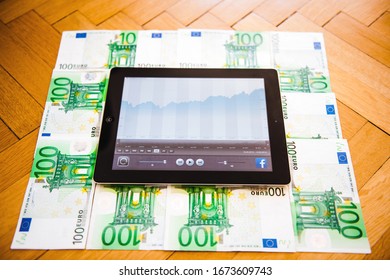 London, United Kingdom - Mar 17, 2014: New Apple Computers IPad Tablet With Graph Showing Evolution Of Facebook Stock Price - Tablet On Floor Surrounded By Multiple 100 Euro Bills