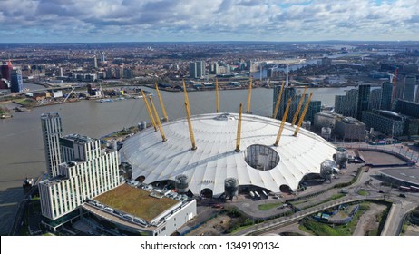 London / United Kingdom - March 18 2019: Aerial drone bird's eye view of iconic concert Hall of O2 Arena in Greenwich Peninsula with beautiful clouds