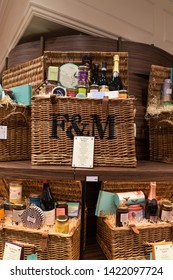 London / United Kingdom - March 20 2017: Full picnic baskets in fancy shop where prices are very high. Baskets are filled with wine bottles, cheese, jam and cream.