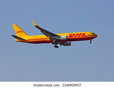 London, United Kingdom, March 2022 - DHL, Boeing 767-300 Cargo Plane coming in to land at Heathrow from left to right across a greyish blue sky