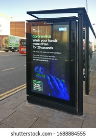 London, United Kingdom - March 31, 2020: NHS Advisory Poster To Wash Hands More Often, Image Of Hand Touching Dirty Door Handle, During Coronavirus Outbreak At Bus Stop In Lewisham, London