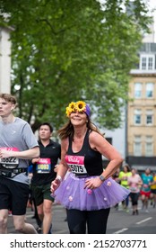 LONDON, UNITED KINGDOM - May 02, 2022: A Vertical Shot Of A Female Runner With Sunflower Headband During Vitality London 10000 