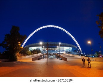 London, United Kingdom - May 22, 2009 : Brightly lit Wembley Stadium at night with people in front