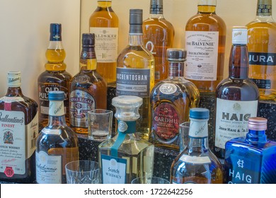 London/ United Kingdom - May 5th 2020 : Various Bottles Of Scotch Whisky, Blended And Single Malts On Bar Shelf. Close Up View.