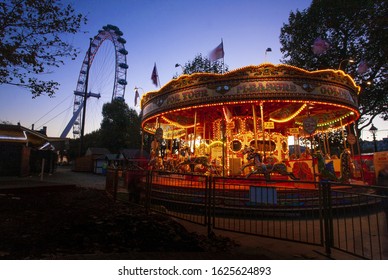 LONDON, UNITED KINGDOM - Nov 11, 2012: Fairground Roundabout Stands On The South Bank In Front Of The London Eye