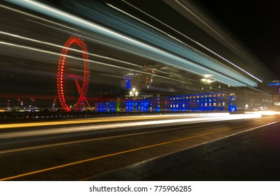 London, United Kingdom - November 9 2017: Night View Of The London Eye Over Westminster Bridge With Fast Moving Lights Of Vehicles Which Reflects The Busy Lifestyle Of The City