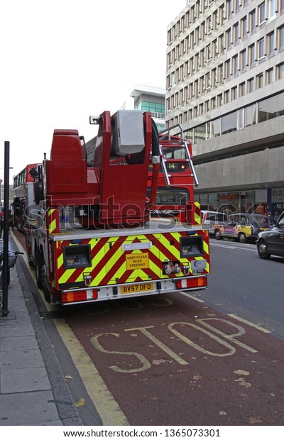 London, United Kingdom - October 08, 2010: A Ladder\
Truck Fire Engine Responding to an Emergency Call at Oxford Street\
in London, UK.