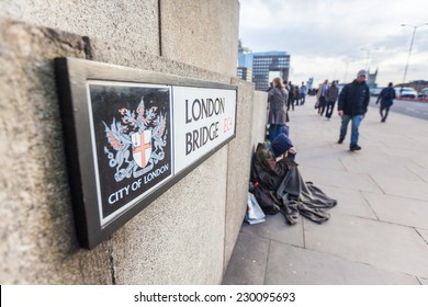 LONDON, UNITED KINGDOM - OCTOBER 24, 2013: Tramp And Commuters On London Bridge