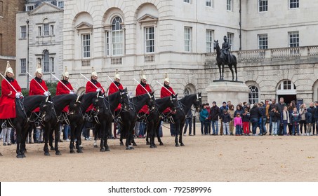 London, United Kingdom - October 29, 2017: Mounted guards outside Horse Guards off Whitehall in London. Tourists watch the ceremony