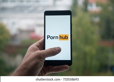 London, United Kingdom, october 3, 2017: Man holding smartphone with Pornhub logo with the finger on the screen