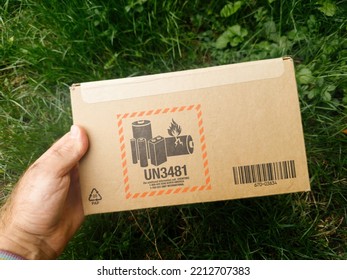 London, United Kingdom - Sep 23, 2022: Rear View Of Apple E-shop Store Delivery Parcel Sent By Syncreon Technology With Apple Watch Ultra And UN3481 Sticker - Garden Background