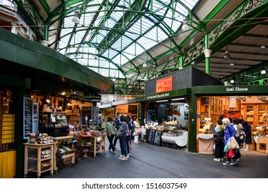 London / United Kingdom — September 26, 2019: food stalls on the Borough Market in Southwark, central London, England, one of the most famous London markets offering street food
