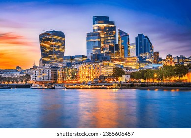 London, United Kingdom. Skyline view of the famous City of London during blue hour. View includes Thames River, skyscrapers, office buildings and beautiful sky. - Powered by Shutterstock