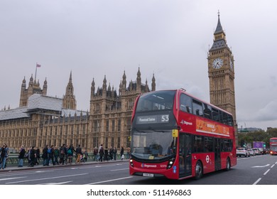 LONDON, UNITED KINGDOM-18 OCT 2016: Big Ben And Houses Of Parliament With Typical British Weather Taken From Busy Westminster Bridge With Moving London Bus.