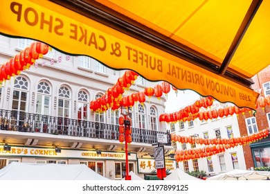 London,Chinatown,Soho,UK4.09.2022 The Famous Gerrard Street In London W1 Is Adorned With Chinese Lanterns On Every Corner.Each Restaurant Seems Busy With Hungry Customers!Kowloon Sign Backwards !