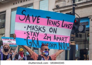 LONDON/ENGLAND- 12 September 2020: Protester holding a transgender flag sign encouraging social distancing at Trans Pride 2020 in London, amid the Coronavirus pandemic