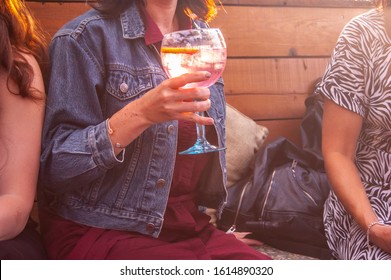 LONDON/ENGLAND – JULY 18 2019: Woman Drinking Pink Gin In A Beer Garden In London