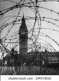 London's Big Ben with barbed wire entanglement and soldiers on guard during World War 2. Ca. 1940-41.
