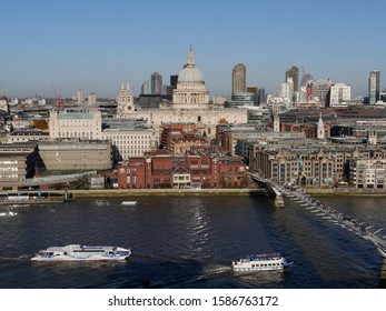 London/UK - 11.29.2019: The Great Dome Of Christopher Wren's St Paul's Cathedral Reaches Up To The Sky. In The Foreground Is Millenium Bridge Crossing River Thames.