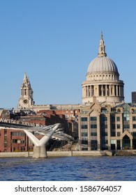 London/UK - 11.29.2019: The Great Dome Of Christopher Wren's St Paul's Cathedral Reaches Up To The Sky. In The Foreground Is Millenium Bridge Crossing River Thames.