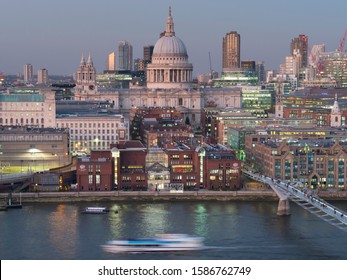 London/UK - 12.04.2019: The Great Dome Of Christopher Wren's St Paul's Cathedral Reaches Up To The Sky At Dusk. In The Foreground Is Millenium Bridge Crossing River Thames.