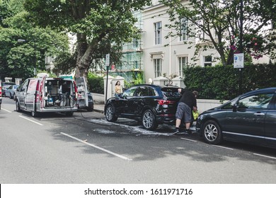 London/UK - 17/07/2019: Mobile Car Washing Service On London Street. Water Tank And A Pressure Washer, As Well As A Generator Mounted On A Van, Allows Washing Cars Parked On The City Streets