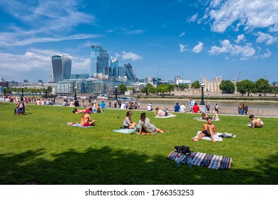 LONDON,UK - JULY 25,2019 : People Enjoying Summer Near Tower Bridge In London With A View Of The City Skyline