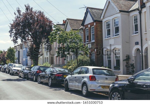 London/UK-1/08/18:\
pastel-colored terraced houses on White Hart Lane in Barnes.\
Terrace house is a form of medium-density housing, whereby a row of\
attached dwellings share\
sidewalls