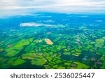 London,UK,16th May 2024:Aerial view of West Sussex county and Gatwick Airport in the distance from departing plane against cloudy skies