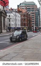 London/UK-22/07/18: Black Cab Waiting On Traffic Light On Bishopsgate. Motorised Hackney Cabs Usually Painted Black And Are Known As Black Cabs, Although They Are Now Produced In A Variety Of Colors