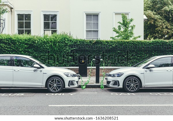 London/UK-30/07/18: two white Volkswagen
Golf GTE cars charging at a charging point on a street in London.
The Golf GTE is a plug-in hybrid version of the Golf
hatchback