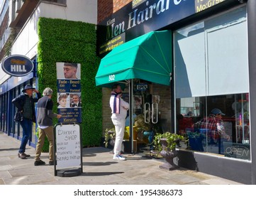 London.UK.April 12th 2021.Men Queue Outside A Chelsea Barbershop On The First Day After Lockdown.