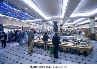 LONDON,UK-AUGUST 26,2011: Men Serve Customers In The Harrods  Food Zone. At Harrods Commercial Center.With Over One Million Square Feet Of Selling Space In Over 330 Departments, Harrods Is The Biggest