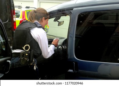               London.UK.September 11th 2018.A Policewoman Does A Check On A Motorist In A London Street.                 