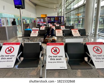 London,UK/September 25,2020：Tourists With Face Mask And Sitting With Social Distance In Heathrow Airport.