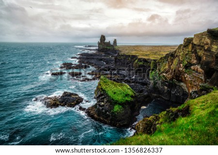 Londrangar in Snaefellsnes National Park, Iceland. Londrangar and hill Svalthufa are remains of a crater, which has been eroded to present form by sea. It is the tourist destination of west Iceland.