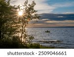 A lone boat floats on Lake Nipissing as its rider enjoys the beautifully colour sunset in North Bay, Ontario.