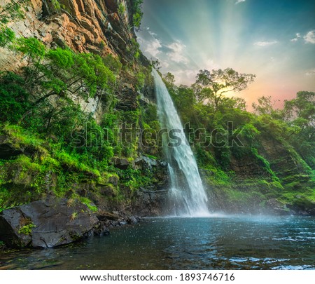 Lone creek waterfall and pond below during colorful sunset  in Sabie Mpumalanga South Africa