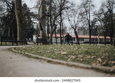 A lone cyclist rides along a path in a tranquil park setting with empty benches and leafless trees, symbolizing solitude and serenity. - Powered by Shutterstock