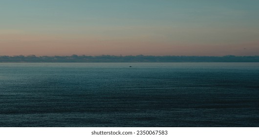 A lone fishing boat coming to shore in Madeira Island after a fishing trip in the Atlantic.