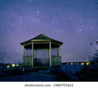 A lone gazebo sits under the stars at the end of a hiking trail, overlooking Lake Muskoka in the small cottage town of Gravenhurst, Ontario. - Powered by Shutterstock