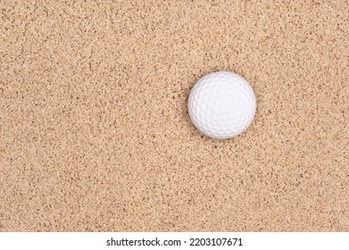 A Lone Golf Ball In A Sand Trap Looking Top Down With Plenty Of Room For Placement Of Copy.