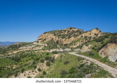 Lone Hiking Trail Leads Along The Side Of A Rocky Canyon Valley Near Santa Clarita.