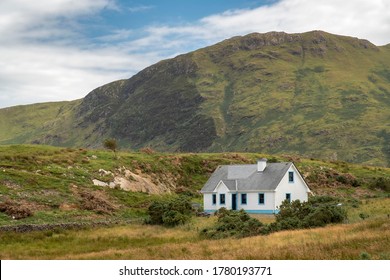 Lone house in Connemara with mountain in the background. Co. Mayo, Ireland. July 2020