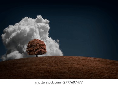 A lone, large maple tree on a grassy hilltop, against the backdrop of a huge, dramatic cloud in a dark blue sky. Concept of loneliness, autumn landscape, minimalist contrast scene