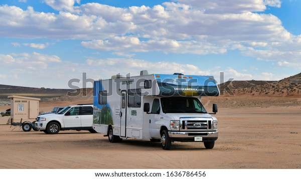 Lone Rock Beach, Utah / September 16, 2018:\
Free-standing sandstone rock is the namesake of one of the most\
popular beaches in the Glen Canyon National Recreation Area. RV\
parked on the beach.