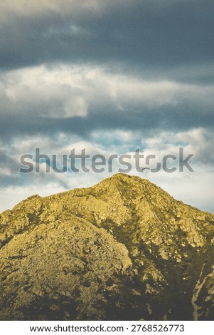  Lone seagull flying over dramatic rocky mountain peak dramatic cloudy sky norway