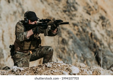 Lone soldier in a desert setting with full equipment aiming. Concept 