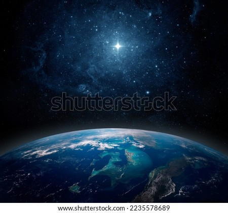 A lone star above the planet Earth. View from space to the starry sky and the planet Earth. Elements of this image furnished by NASA. 