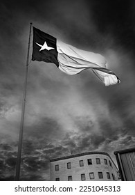 Lone Star Texas State Flag waving in the wind over Odessa in Texas, USA, dramatic cloudscape in black and white colors